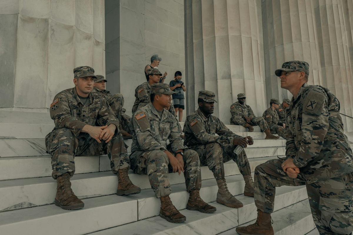 Military personnel boarding a transport aircraft.