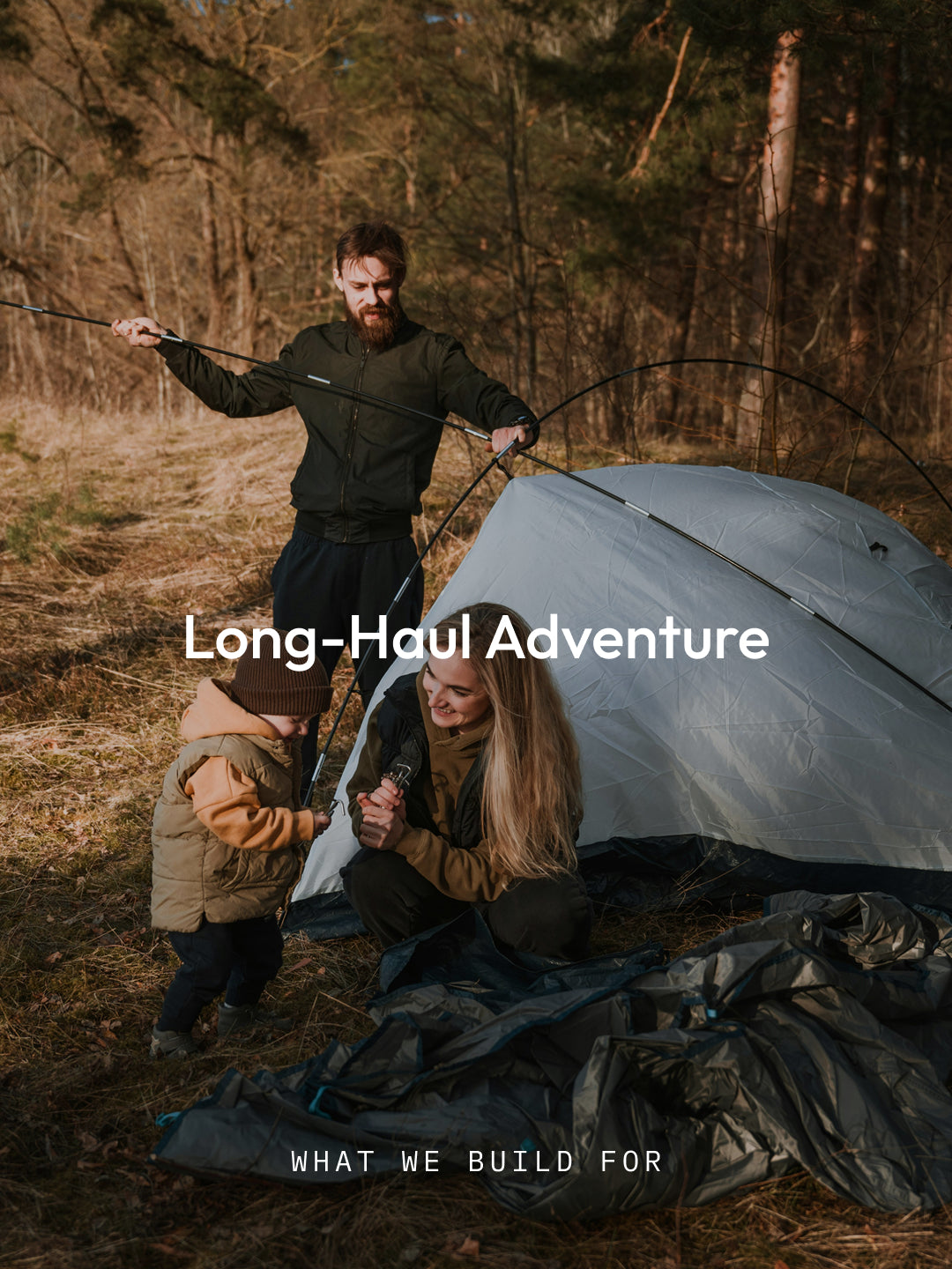 family camping outdoors and setting up a tent