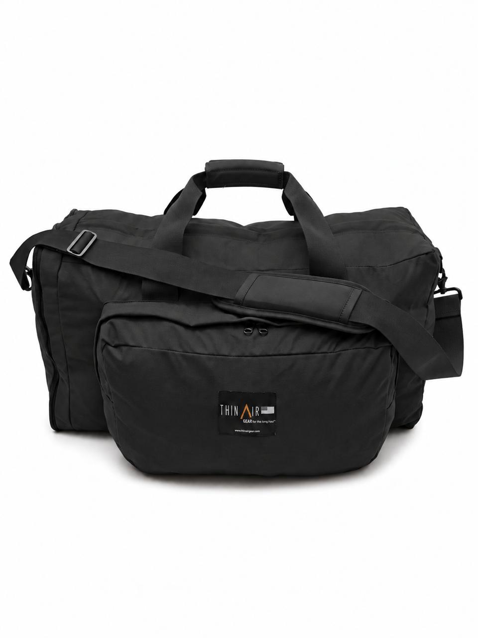 black duffel on white background with shoulder strap
